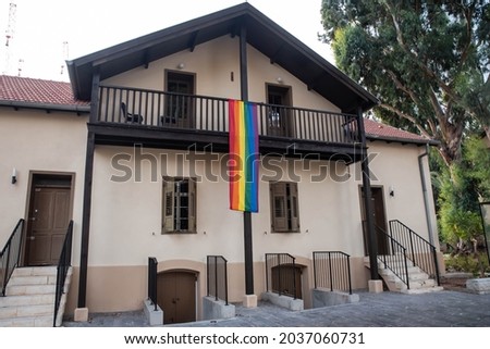 House facade windows decorated with the LGBT rainbow flag, gay pride