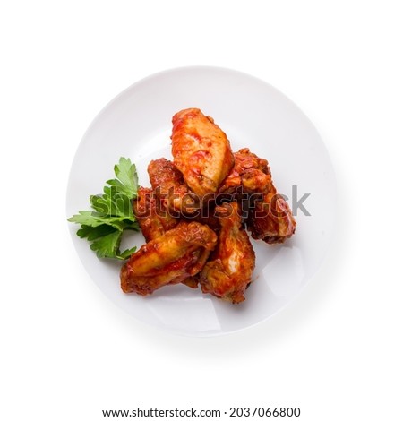 chicken wings in barbecue sauce on white plate isolated on white background top view Royalty-Free Stock Photo #2037066800