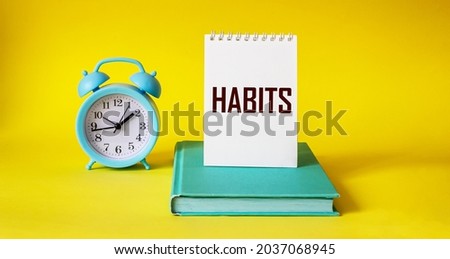 Habits word written on notepad and yellow background Royalty-Free Stock Photo #2037068945