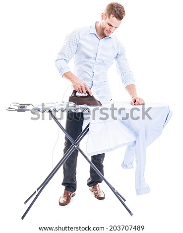 Happy young man ironing on a ironing board, isolated on white background