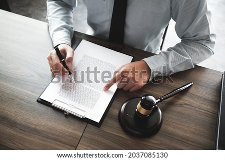 Lawyer Legal counsel presents to the client a signed contract with gavel and legal law. justice and lawyer Business partnership meeting  Royalty-Free Stock Photo #2037085130
