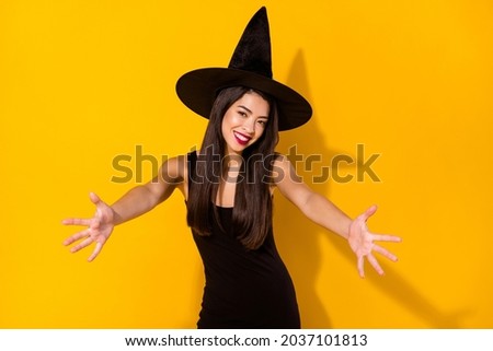 Photo of sweet young brunette hairdo lady hug you wear black dress witch cap isolated on yellow color background
