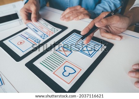 Creative Web Designer planning application and developing template layout, framework for mobile phone. User experience (UX) concept.