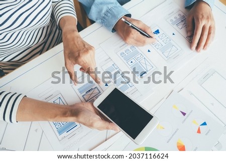 Creative Web Designer planning application and developing template layout, framework for mobile phone. User experience (UX) concept.