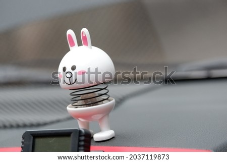 Close up of peer doll on the car dashboard. Side view close up details.