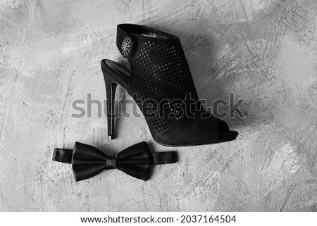 Female shoe and male bow tie. Bow tie and high heel shoe glyph icon. Silhouette symbol. Party dress code. Negative space.  Royalty-Free Stock Photo #2037164504