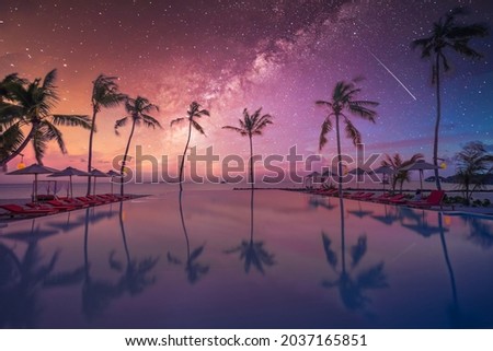 Palms chairs around infinity swimming pool near sea ocean with palm trees beach at night sunset time. Lifestyle leisure carefree travel vacation, summer resort landscape. Fantasy nature landscape Royalty-Free Stock Photo #2037165851