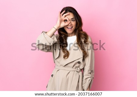 Woman over isolated background showing ok sign with fingers