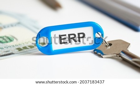 real estate rent concept - key with tag ERP. the key is on the office desk. ERP - short for enterprise resource planning