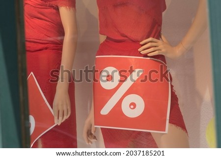 sale sign at a shop, shopping at a lower price