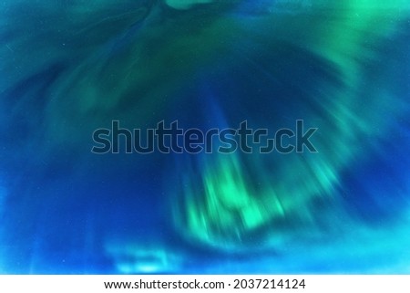 Aurora borealis, Northern green blue lights with starry in the night sky, background picture. Real photo