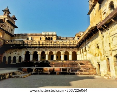 Jahangir Mahal at Orchha fort complex of Madhya Pradesh with fabulous architectural documentation and blue sky in the background .