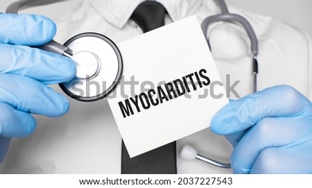 Doctor holdnd stethoscope and paper sheet woth text Myocarditis. Medical concept Royalty-Free Stock Photo #2037227543