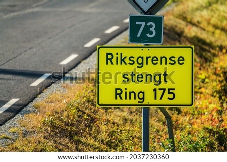 "State border is closed" is written on Norwegian on road sign checkpoint between Sweden and Norway. Corona restrictions stops travel over certain checkpoints. Close up photo Royalty-Free Stock Photo #2037230360