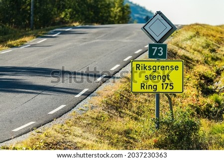 "State border is closed" is written on Norwegian on road sign checkpoint between Sweden and Norway. Corona restrictions stops travel over certain checkpoints. Royalty-Free Stock Photo #2037230363