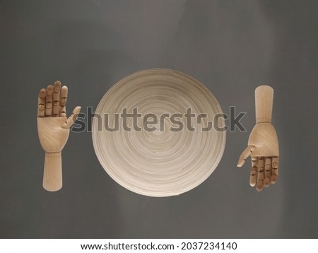 two elegant French wooden hands facing each other on a dark back