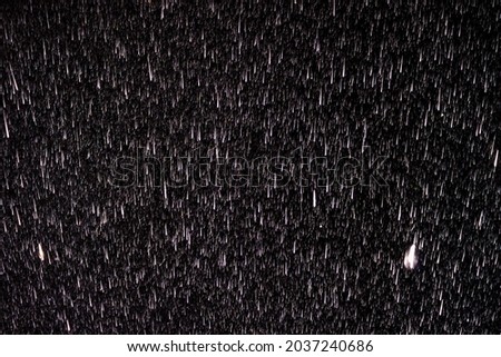 Raindrops on a black background. Rain in the dark. Graphic resource or template for editing. Blank for a retoucher.