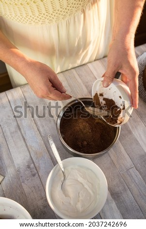 The process of making chocolate glaze. Step by step. The ingredients are mixed in a saucepan. Warm up slowly to dissolve.
