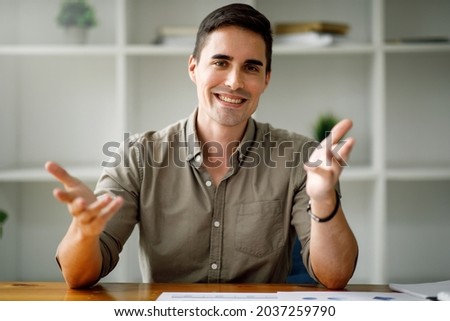 Portrait of around the age of 35,Happy handsome man or businessman looking at webcam making conference video call Royalty-Free Stock Photo #2037259790