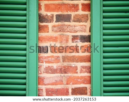 Green Shutters on Colorful Brick Background Macro