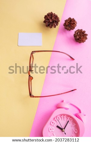 square glasses in the photo in minimal summer style on a pastel pink and yellow background. Alarm Clock , Pine Tree Flowers , Business Cards
