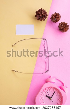square glasses in the photo in minimal summer style on a pastel pink and yellow background. Alarm Clock , Pine Tree Flowers , Business Cards
