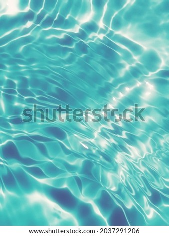 Blur​ abstract​ of​ surface​ blue​ water. Abstract​ of​ surface​ blue​ water​ reflected​ with​ sunlight​ for​ background.