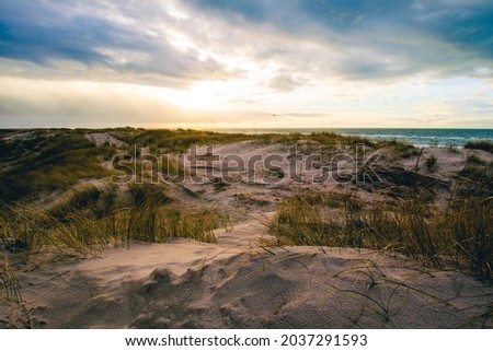 A beautiful view of the coast under storm clouds at sunset in Denmark