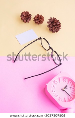 oval glasses in the photo in minimal summer style on a pastel pink and yellow background. Alarm Clock , Pine Tree Flowers , Business Cards
