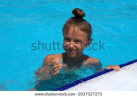 The girl swims in a warm pool