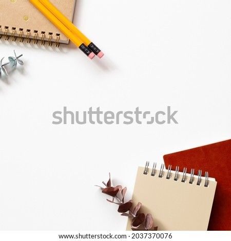 Notebook, pencil, eucalyptus leaf on white background. flat lay, top view, copy space. workspace