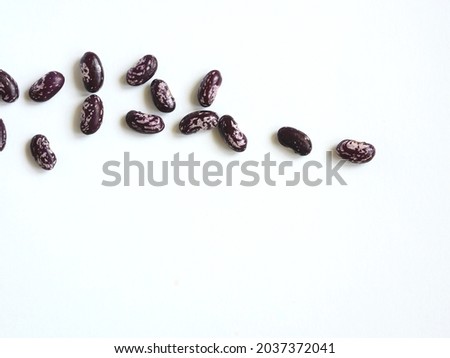Beans are sprinkled on a white table. Place for your text.