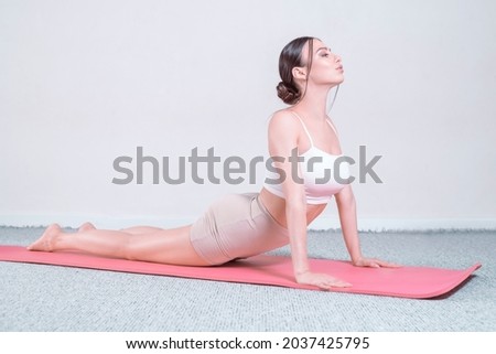 Sporty young woman doing yoga practice. The concept of a healthy lifestyle and natural balance between body and mind. Pilates, stretching. Mixed media