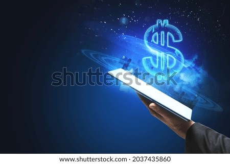 Close up of hand holding tablet with creative glowing polygonal dollar city hologram on blurry blue background with mockup place. Cryptocurrency, online banking, price and trade concept