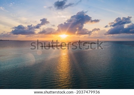 Fantastic Maldivian uninhabited islands on the sunrise. July 2021, aerial drone picture.
