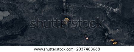 Banner aerial top view open mine, Excavator loads anthracite for crushing into coal crusher.