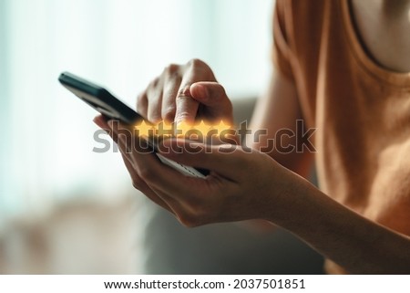 Close up of woman customer giving a five star rating on smartphone. Review, Service rating, satisfaction, Customer service experience and satisfaction survey concept. Royalty-Free Stock Photo #2037501851