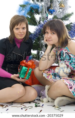 The two attractive girls with gifts isolated on a white background