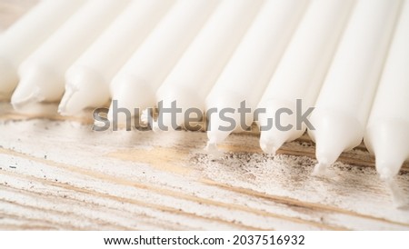 New white candle set on wooden table. Long wax candles. Set of traditional candles. Lots of new long white wax candles Royalty-Free Stock Photo #2037516932