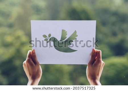 Show Cut paper with the logo of pigeon template of peace concept,International Peace Day Royalty-Free Stock Photo #2037517325