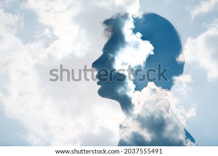 Psychology and man mental health contemplation and atmosphere pressure concept. Multiple exposure clouds and sun on male head silhouette. Royalty-Free Stock Photo #2037555491