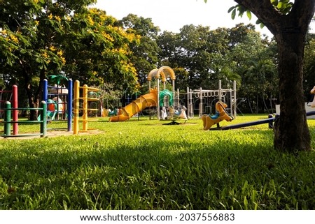 A children Colorful playground on yard in the park. the green grass Royalty-Free Stock Photo #2037556883