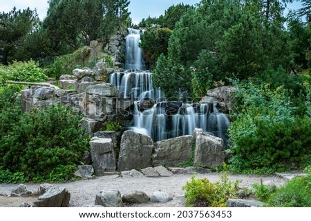 A shot of a landscape and a waterfall in Grugapark, Essen, Germany