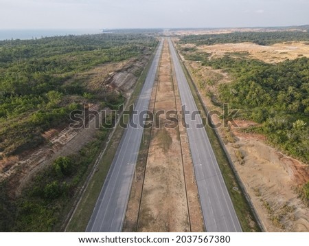 A two-lane expressway or two-lane freeway is an expressway or freeway with only one lane in each direction, and usually no median barrier. It may be built that way because of constraints. Royalty-Free Stock Photo #2037567380