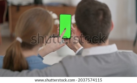 Rear View of Couple using Smartphone with Green Chroma Key Screen