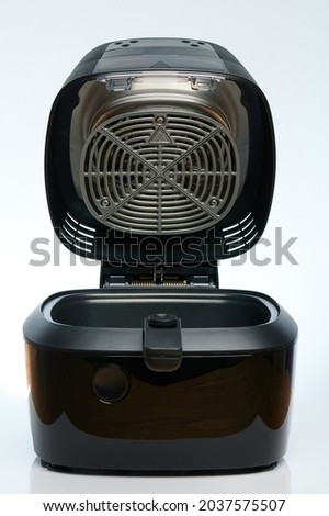 Opened black empty air frier isolated on white studio background Royalty-Free Stock Photo #2037575507