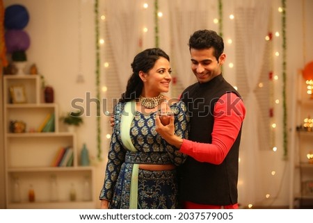 Couple celebrating diwali with full of happiness Royalty-Free Stock Photo #2037579005