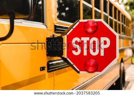 Yellow school bus. Stop sign. Be careful, schoolchildren crossing the road. New academic year semester. Welcome back to school. Lockdown, distance remote education learning