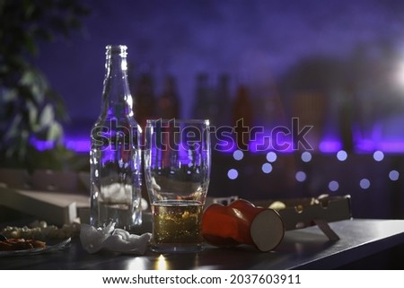 Messy table with beer and food leftovers indoors, space for text. After party chaos Royalty-Free Stock Photo #2037603911
