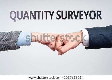 Text sign showing Quantity Surveyor. Internet Concept calculate the cost of the materials and work needed Two Professional Well-Dressed Corporate Businessmen Handshake Indoors